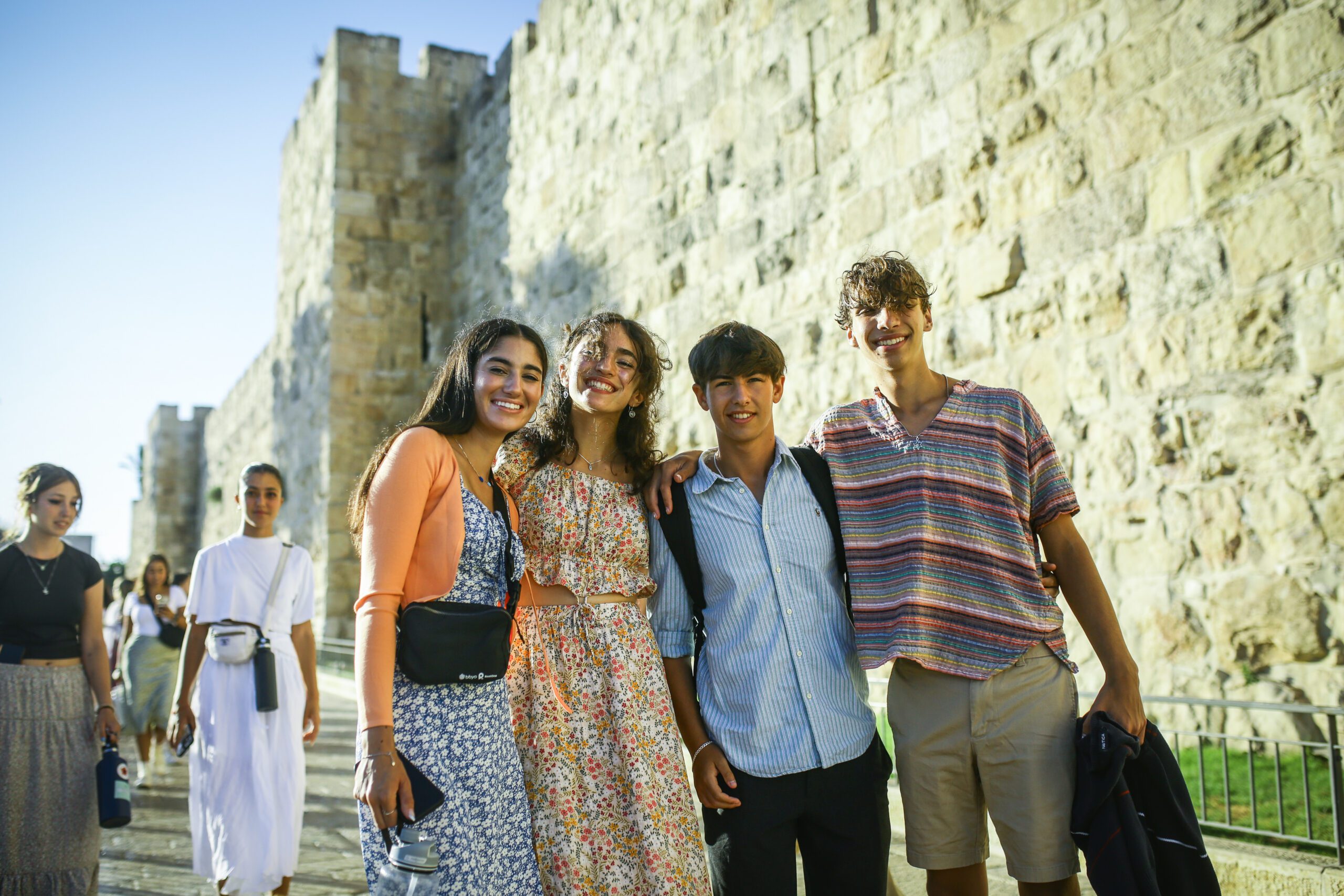B-6 Teens standing arm in arm in front of the entrance to the Old City in Jerusalem
