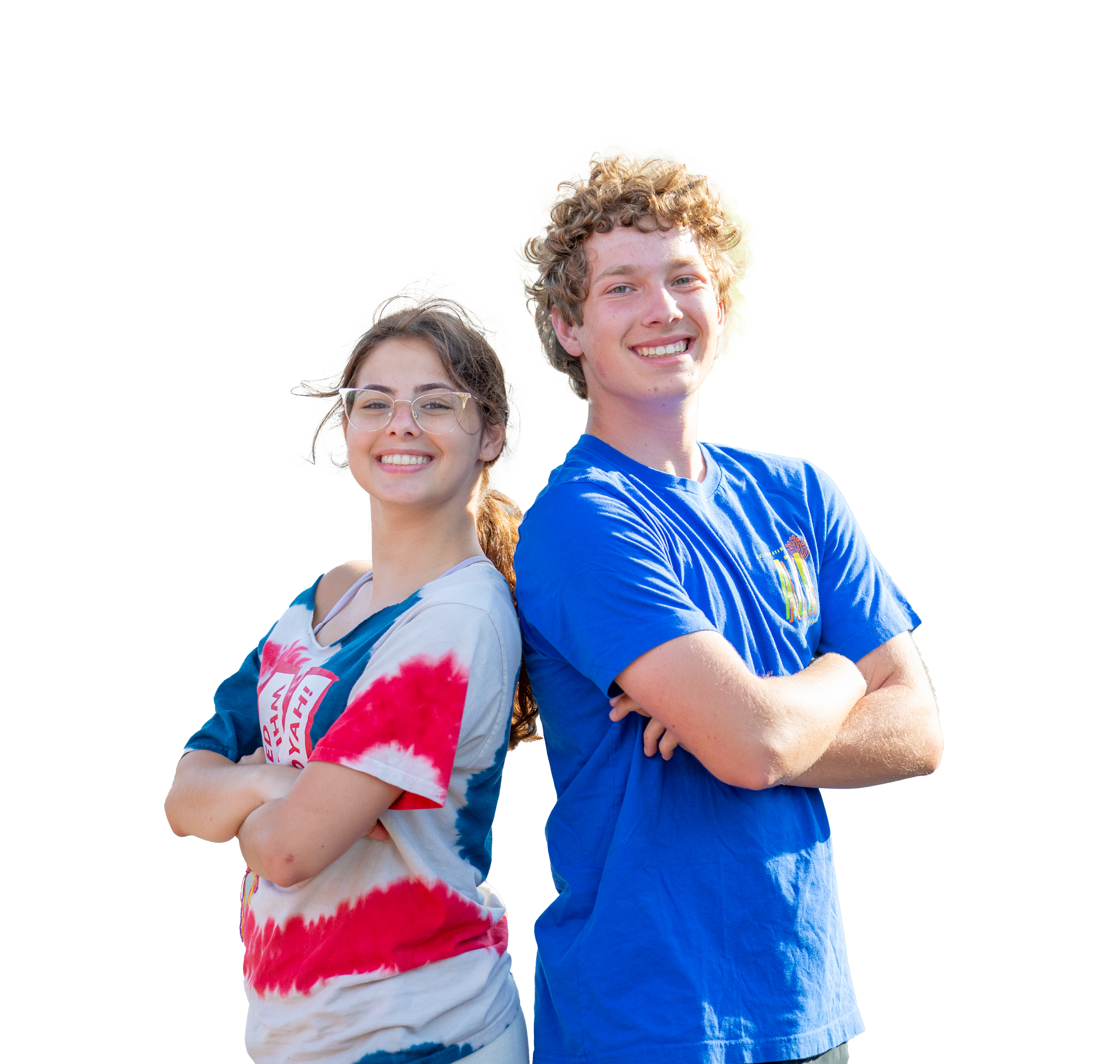 Two teens stand back-to-back, smiling confidently with their arms crossed. The teen on the left is wearing a red, white, and blue tie-dye shirt, while the teen on the right is wearing a blue t-shirt. Both are outdoors, enjoying a bright, sunny day, radiating positivity and teamwork.