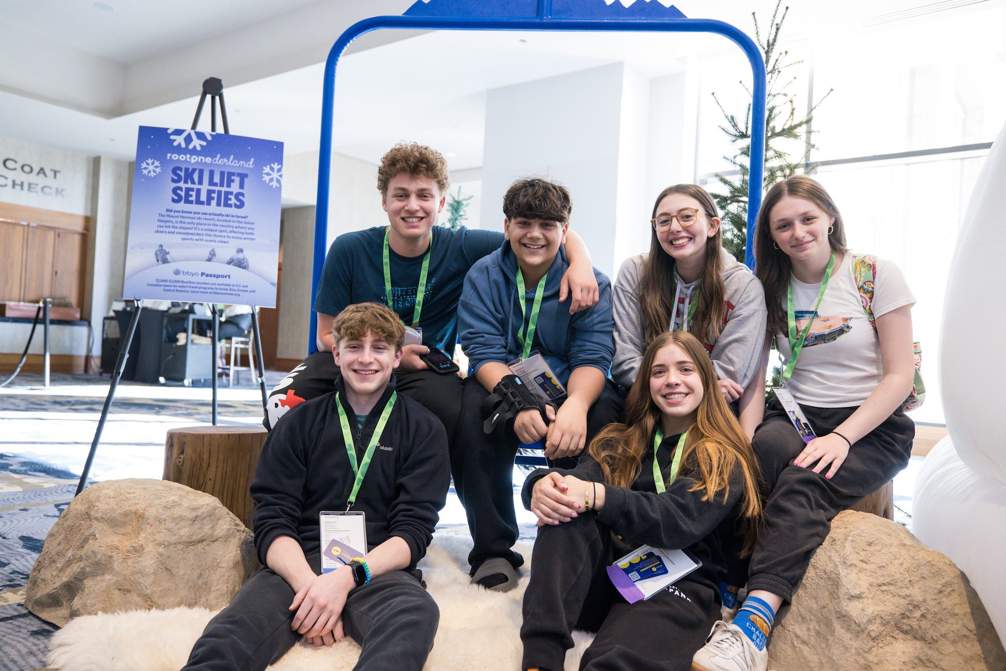 Teens sitting on a ski lift photo prop at BBYO IC in Denver, Colorado in 2025.
